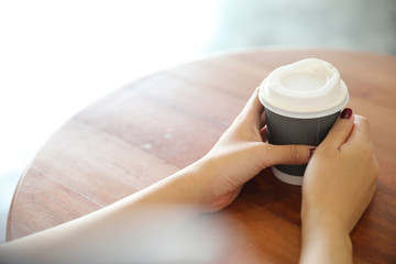 take home hot cappuccino or Latte art coffee made from milk with female hand