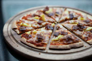 Hawaiian pizza , pizza with ham bacon pineapple in wooden plate