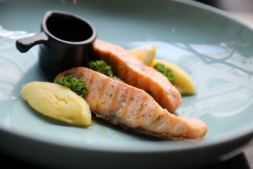 Roasted salmon steak , baked salmon with salad fresh vegetable in restaurant