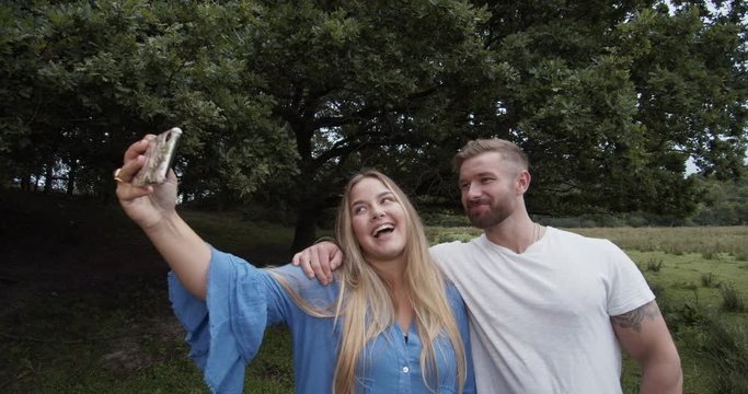 Couple taking a selfie and are in love. Cinematic lifestyle scene perfect for corporate or lifestyle video projects.