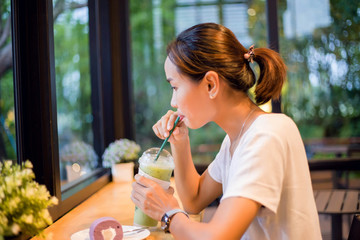 Closeup of woman eating chocolate cake in a cafe