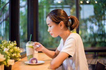 Closeup of woman eating chocolate cake in a cafe