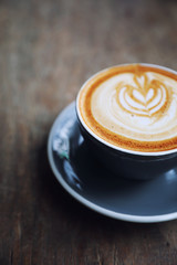 cappuccino or Latte art coffee made from milk on the wood table in coffee shop