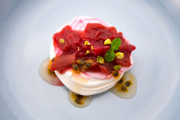 Rhubarb on the top of Pavlova of meringue