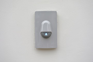 doorbell on white wall of front gate