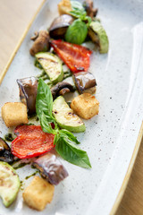 Grilled vegetables with feta cheese. Serving on a plate on a table. Barbecue restaurant menu, a series of photos of different dishes