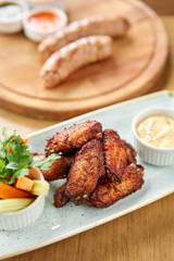 chicken wings grill. Serving on a white plate on a table. Barbecue restaurant menu, a series of photos of different meats
