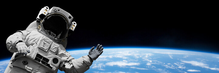astronaut waving during spacewalk in outer space © dottedyeti