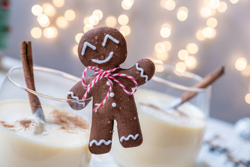 Traditional Christmas drink eggnog with cinnamon and Gingerbread man cookies