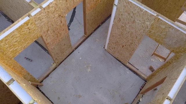 Construction of new and modern modular house. Walls made from composite wooden sip panels with styrofoam insulation inside. Building new frame of energy efficient home concept.