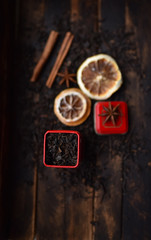 Obraz na płótnie Canvas black tea in a red tin on a dark background