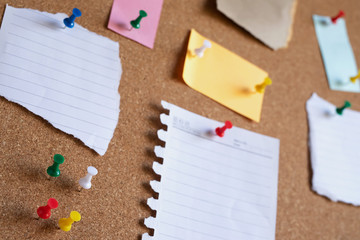 collection of colorful variety post. paper note reminder sticky notes pin on cork bulletin board....