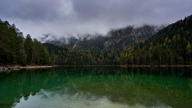 idyllic Blindsee alpine lake timelapse with low clouds obscuring the mountains. Ehrwald, Alps, Austria