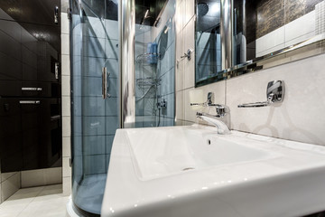 toilet and detail of a corner shower bidet with wall mount shower attachment