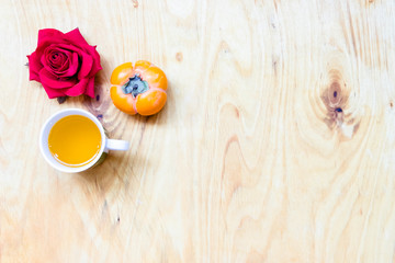Fresh banana and persimmon in brick wall background and wooden table,