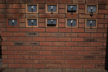Fototapeta na wymiar brick wall with letterboxes