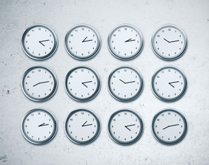 Many wall clocks showing time