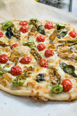 Real Italian Pizza with Zucchini Flowers, Vegetables and Cherry Tomatoes.