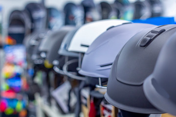 Row of helmets for skateboarding at the shop (showroom or store). Shopping and season sale concept. Sports Accessories.