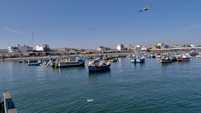 Fishing boats anchored in Paracas pier, in front of Paracas National Reserve, Pisco region, Peru. 