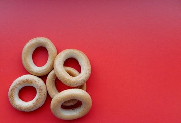 Bagels on a red background, located on the side, with space for text              