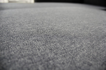 Fototapeta na wymiar Modern sofa seat. Gray upholstery fabric on the sofa seat. Close-up photo, selective focus.