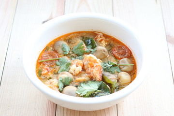 Tom Yum Goong on wood table, Thai traditional food