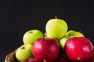 Fresh colorful apple with water drop on skin over gray background - clean fresh fruit background concept