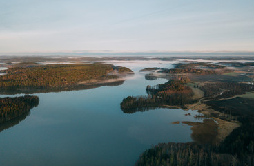 Beautiful landscape of a foggy lake. Aerial view at autumn lake landscape in Finland
