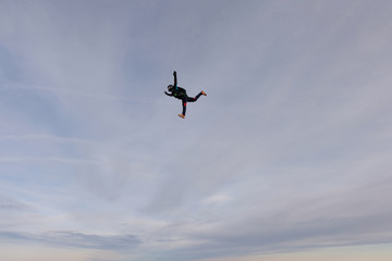 Skydiving. A solo skydiver is flying in the sky