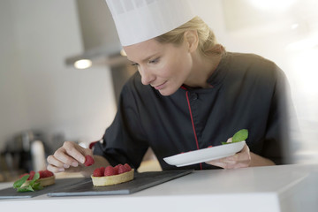 young woman pastry chef in a pastry