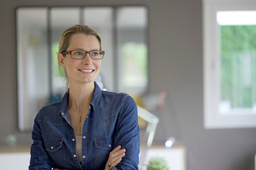 young blond woman face camera in an office