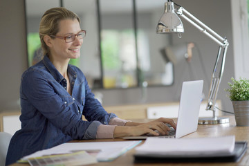 young blond woman working in an office