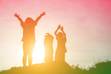 silhouette of a happy children and happy time sunset