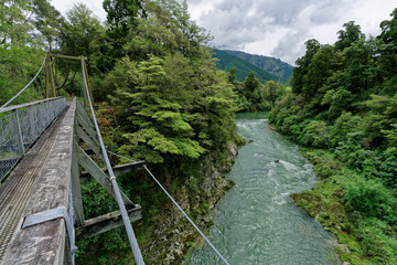 Fototapeta na wymiar Rai river swing bridge at Pelorus, Marlborough, New Zealand.