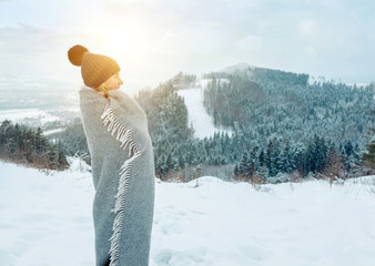 Happy woman traveler on the snowy of mountain look on the nice w