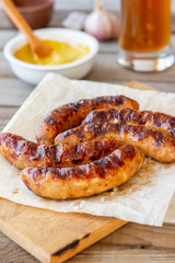 Grilled sausages with mustard and beer. German cuisine.