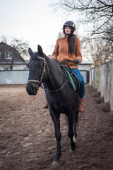 Fototapeta premium Training women and horses while walking on the racetrack.