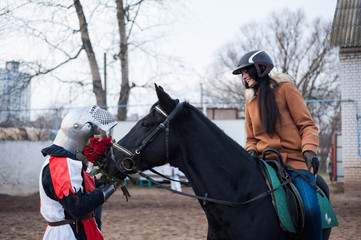 Medieval knight makes the offer of a lady on horseback.