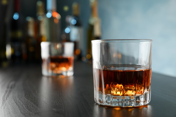 Glasses of whiskey on bar counter, close up