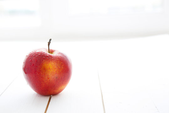 Delicious Appetizing Beautiful Fresh Red Apple Isolated On A White Wood Table Background.