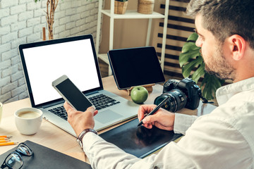 Office worker doing his job sitting at his working table with a computer