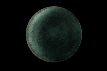 Abstract image of planet Uranus from the surface of an old griddle on a black background in space.
