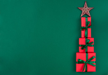 Christmas tree with gifts boxes. Red gift boxes in the form of christmas tree . Christmas card. Flat lay. Top view with space for text	