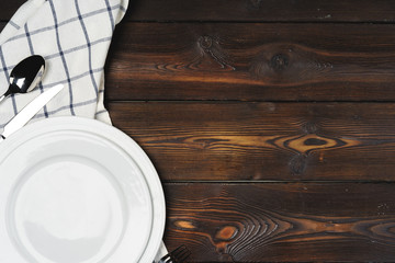 Table setup with plates on dark wooden background