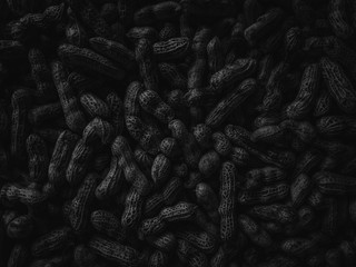 Dark black texture peanuts background. Can be use for your design, advertising, health, food, backdrop, product display or montage. Close up