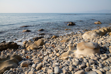 Fototapeta na wymiar bizarre sea pebbles and the sea shore