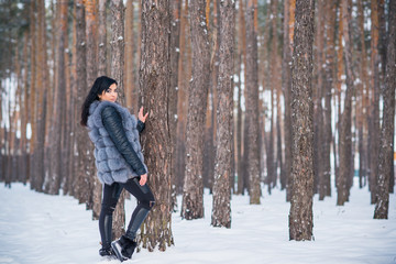 Naklejka premium Winter holidays concept. Arabic woman in stylish look at snowy day outside