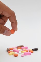 holding pills on white background