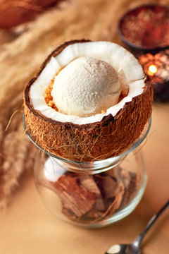 Ice cream with nuts and lemon sauce in halved coconut.